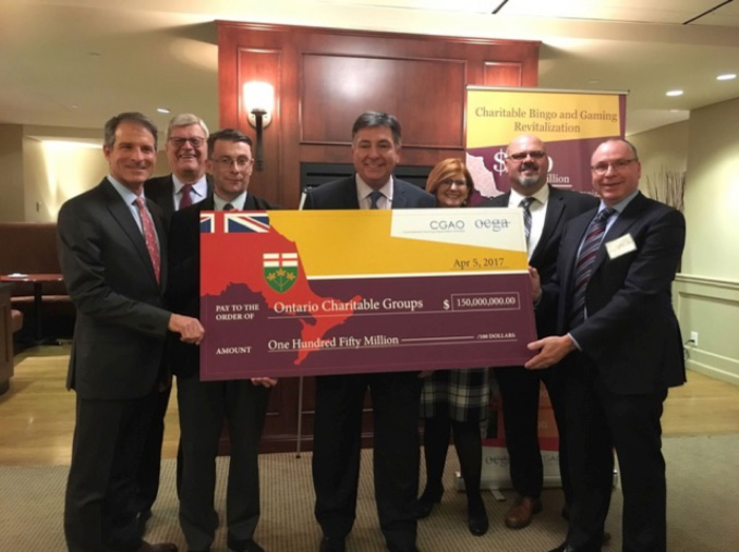 Minister of Finance, Hon. Charles Sousa receives cheque for 150 million canadian dollars