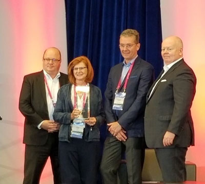 Ms. Lynn Cassidy receives her award from Mr. Jean Major, Mr. George Sweny and Mr. Paul Burns